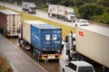 Large semi-trailer trucks with container cargo