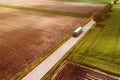 Large semi-truck on countryside road seen from drone pov, aerial shot of trucking and logistics concept