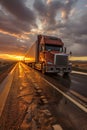 A large semi truck driving down a desert road at sunset