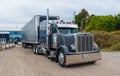 Large semi truck parked in a gravel slot