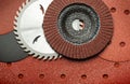 A large set of abrasive tools and grinding discs on the background of sandpaper. Tools used by master builders