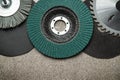 A large set of abrasive tools and grinding discs on the background of sandpaper. Tools used by master builders