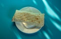 Large shawarma on a white plate with a napkin on a blue background with shadows. Food, healthy fast food, delicious to