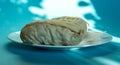 Large shawarma on a white plate with a napkin on a blue background with shadows. Food, healthy fast food, delicious to