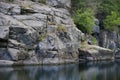 A large sheer cliff above the water Royalty Free Stock Photo