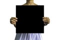 A large sheet of black paper in female hands isolated on white background with clipping path Royalty Free Stock Photo