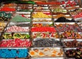 Large shelf full of gummy candy trays of different flavors and colors in a sweets store