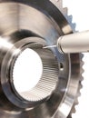 Large shiny engine part, turbine with bearing, gear, stainless steel part. Vertical format