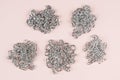 Large shiny metalic silver chains on pastel surface top view. Set of different chains Royalty Free Stock Photo