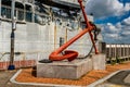 Large ship anchor in front of retired military frigate Royalty Free Stock Photo