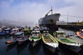 A large ship and fishing boats at the pier in the port of Valparaiso. Chili