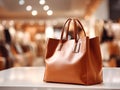 A large shopping bag stands on the table in front of the background of the mall. The concept of successful shopping