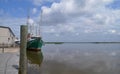 Large shrimp boat at dock by open water