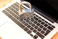 Large silver metal lock on a modern laptop, concept of protecting information, passwords and child locks, close-up, copy space
