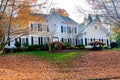 Large single-family country house with yellow trees and foliage in the frontyard. Autumn landscape Royalty Free Stock Photo