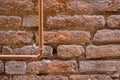 Ancient stone wall and copper pipe Royalty Free Stock Photo