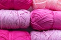 Large size pink and purple balls of elongated woolen acrylic or nylon yarn, taken in full frame close-up on the theme of hobby,