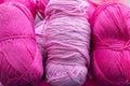 Large size pink and purple balls of elongated woolen acrylic or nylon yarn, taken in full frame close-up on the theme of hobby,