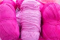 Large size pink and purple balls of elongated woolen acrylic or nylon yarn, taken in full frame close-up on the theme of hobby,