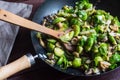 Large skillet with delicious looking sauteed brussels sprouts and mushrooms, wood turner