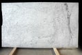 A large slab of natural white marble with gray veins is called Bianco Gioia