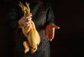 A large slaughtered rooster in the chef hand. Cock presentation before preparing a delicious dish in the restaurant kitchen.