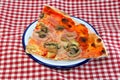 Pizza garnished with a lot of ham mushrooms mozzarella and fresh Royalty Free Stock Photo