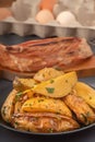 Large slices of baked potatoes on the background of a smoked piece of meat.