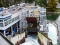 A large sluice drains water. Docking station for a car ferry. Aquamarine and port technology on a river