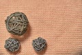 Large and small balls of rattan on knitted fabric. Beig background. View from above. Copy space, flatlay. Royalty Free Stock Photo