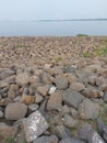 large and small boulders that protect the beach