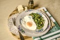 Large and small snack barsÃÂ porcelainÃÂ dishes with spinach and fried eggs