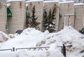 A large snowdrift against the background of a wall of a brick building. Royalty Free Stock Photo