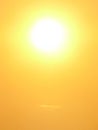 A large solar disk at sunset orange sky