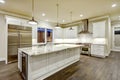 Large, spacious kitchen design with white kitchen cabinets Royalty Free Stock Photo