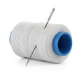 Large Spool of White Thread with Two Sewing Needles Inserted Royalty Free Stock Photo