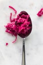 A large spoon filled with pickled beet and red cabbage sauerkraut. Royalty Free Stock Photo
