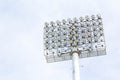 Large spotlights at the outdoor stadium under the blue sky