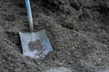 A Large Square Shovel Resting on a Pile of Mulch Royalty Free Stock Photo