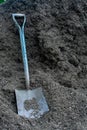 A Large Square Shovel Resting on a Pile of Mulch Royalty Free Stock Photo