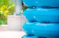 Stack of blue swim ring for water park slide on water park pool side Royalty Free Stock Photo