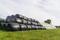 Large stack of hay bales wrapped in plastic. UK Royalty Free Stock Photo