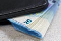 Large stack of money worth 20 euros are stick out of the purse Royalty Free Stock Photo