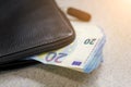 Large stack of money worth 20 euros are stick out of the purse. Toned image Royalty Free Stock Photo