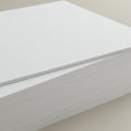 A large stack of neatly arranged A4-sized white paper with clean edges, resting on a Royalty Free Stock Photo