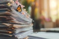 Large stack of papers on the desk, paperwork left undone, spring, butterflies Royalty Free Stock Photo