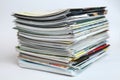 A large stack of printing magazines on a white background. Lots of different publications. Royalty Free Stock Photo