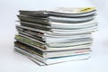 A large stack of printing magazines on a white background. Lots of different publications. Royalty Free Stock Photo
