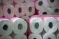 A large stack of toilet paper. A stockpile toilet paper with pink print in packaging