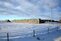 Large Stacks of Hay Bails on a Snowy Farm Field in Winter Royalty Free Stock Photo